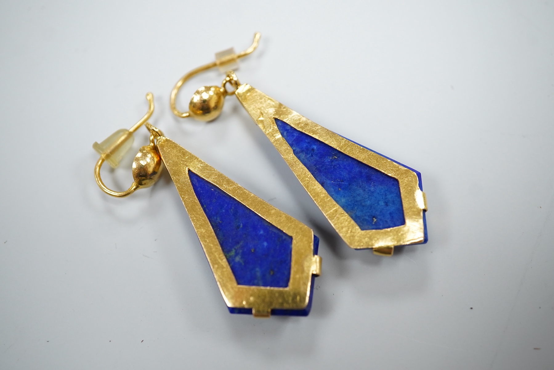 A pair of yellow metal and angular cut lapis lazuli set drop earrings, overall 42mm, gross weight 8.6 grams.